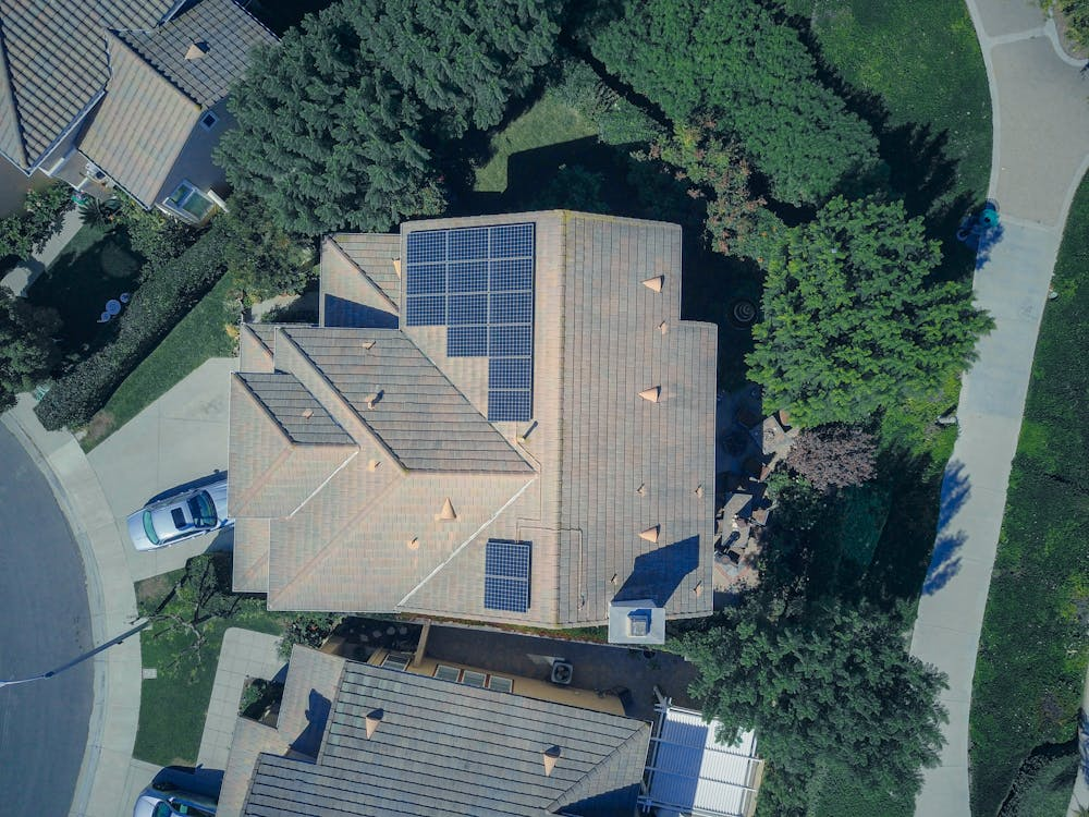 drone view of a rooftop with solar panels